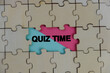© Ardini - the words Quiz Time beside mini alarm clock on a plain background. the concept of answering quizzes or quiz games. text space