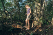 © Westend61 - Smiling girl balancing and walking on tree trunk in forest