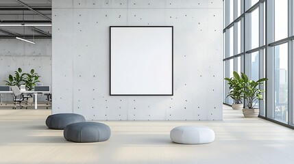 Poster - Spacious and modern industrial style office interior with clean concrete walls an empty poster frame and soft natural sunlight streaming in through large windows