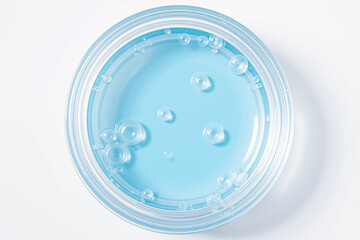 Poster - A clear bowl filled with blue liquid and bubbles, showcasing a clean and refreshing aesthetic ideal for product photography or design.