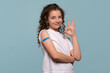 © Vagengeim - Smiling girl making an 'OK' gesture after vaccinated