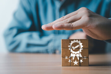 Fototapete - Businessman hand protecting five stars quality icon which print screen on wooden block cube for quality control certificate and guarantee product and service