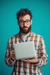 © Fathor - photo portrait of mischievous adult man, 25-30 aged, with laptop, casual clother, it, lifestyle, realistic skin, European, medium shot, 50 mm, blue background,generative ai