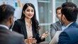 © N7 - An Indian woman presenting key business insights to colleagues during a meeting.