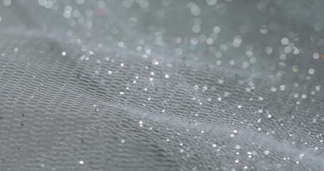 Gray tulle fabric with sparkling glitter.