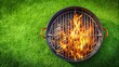 © Collection - A Round Grill With Orange Flames Burning Within Its Metal Bars on a Lush Green Grass Surface
