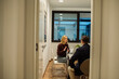 © Marko Geber - Diverse colleagues talking in modern office sitting space