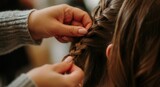 Close-up shot of person braiding hair with expertise
