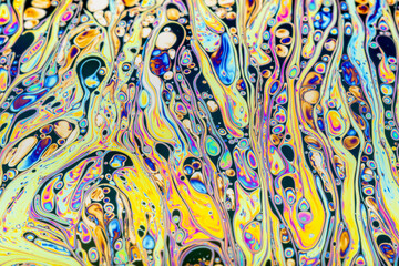 Wall Mural - Real photograph of a colorful light diffraction on a soap bubble surface with random swirls, curves and lines