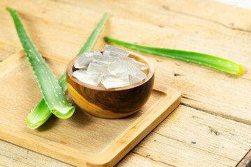 Wall Mural - aloe vera and pieces of its pulp on a wooden pit