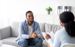 © Prostock-studio - Effective psychotherapy. Young black guy talking to his psychologist, receiving professional help at mental health clinic. African American male patient sharing therapy results with counselor