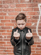 © InputUX - Young boy posing with rebellious gesture