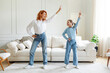 © Home-stock - Joyful mom and teen girl having fun and dancing at home in living room interior, full length. Entertainment, love, healthy family relationships