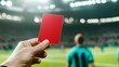 © Nazlykhan - Referee holds red card during soccer match in stadium lighting