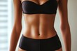 © Ева Поликарпова - A close-up shot of a woman wearing a black bikini, perfect for fashion or beauty related concepts