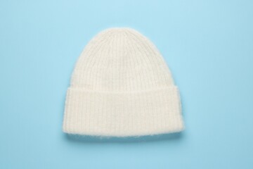 Sticker - Warm woolen hat on light blue background, top view