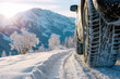 © SunFlower - Closeup of car tires in snowy winter day during snowfall by road among mountain, low view, banner