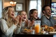 © Larisa - Family enjoying game on TV with joy and snacks