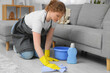 © Pixel-Shot - Female janitor cleaning floor in room
