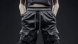 © JSR Art Studio - Close-up of stylish black cargo pants, showcasing modern fashion design and details.