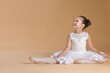 © New Africa - Portrait of little ballerina on beige background
