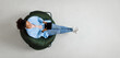 © Prostock-studio - People And Modern Technology. Above top view of young smiling black lady holding tablet sitting on bean bag in living room, watching video. Cheerful lady surfing internet, free copy space, panorama