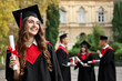 © New Africa - Happy students with diplomas after graduation ceremony outdoors, selective focus