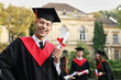 © New Africa - Happy students with diplomas after graduation ceremony outdoors, selective focus