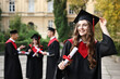 © New Africa - Happy students with diplomas after graduation ceremony outdoors, selective focus