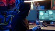 © DC Studio - Tracking shot of hooded spy in underground hideout stealing valuable data by targeting governmental websites with weak security. Espionage specialist using tablet to launch cyber attacks
