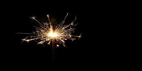 Leinwandbilder - A sparkler firework featuring black copyspace.
