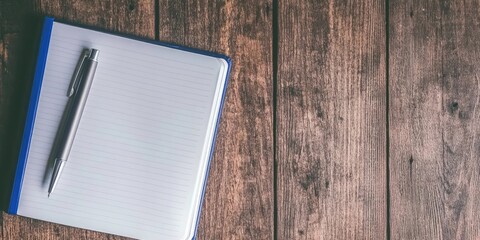 Aufkleber - Closeup of a notebook and pen on a wooden table.