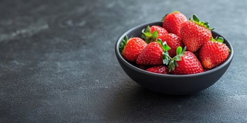 Poster - Fresh, ripe strawberries in a bowl on a dark background. Copyspace.