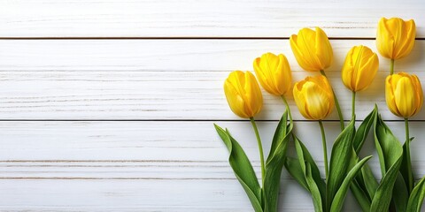 Sticker - Yellow tulips on a white wooden background with copyspace.