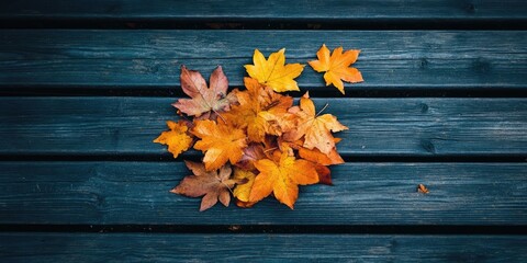 Sticker - Bunch of autumn leaves on a wooden surface.