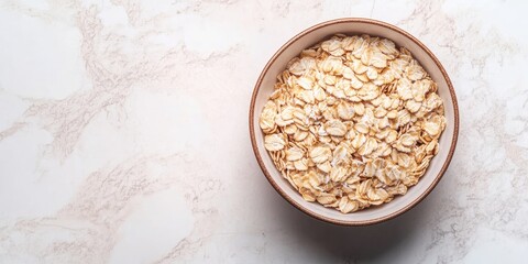 Canvas Print - Dry oatmeal in a bowl on a light background. Healthy breakfast. Concept of dieting and weight loss. Flat lay, top view, copyspace.