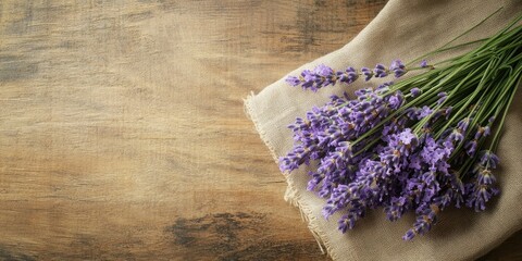 Poster - A bundle of lavender flowers resting on a cloth on a wooden surface with copy space. A bundle of lavender flowers resting on a cloth on a wooden surface with copy space.