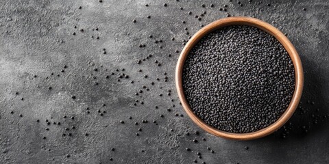 Poster - Poppy seeds in a bowl on a grey table, seen from above. Copyspace available.