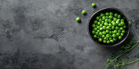 Canvas Print - Bowl containing fresh green peas on a grey tiled table.