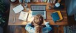 © Almahyra - Woman working from home at a desk with a laptop, papers, and a plant.