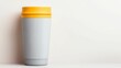 © Nitchalee N. - tumbler mockup and minimalist, A stylish, reusable coffee cup with a textured gray body and a vibrant yellow lid, set against a minimalist background.