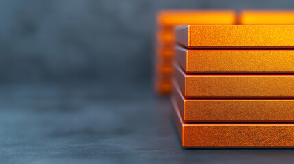 Poster - Sleek orange metal blocks stacked on textured surface, showcasing modern design