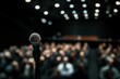 © jambulart - Microphone on stand, audience blurred background.