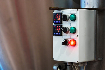 Poster - a control panel with two digital displays shows the temperature and pressure in a factory
