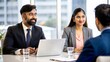 © N7 - An Indian couple presenting a business proposal to potential investors in a meeting room.