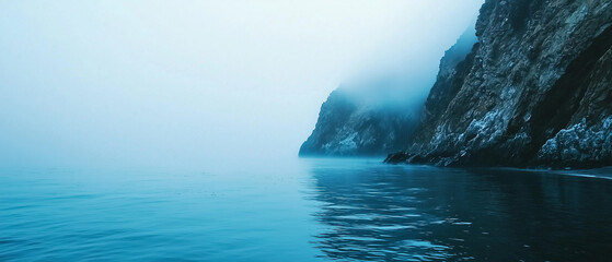 Poster - serene coastal scene with dense fog enveloping rocky cliffs and calm waters, creating tranquil and mysterious atmosphere