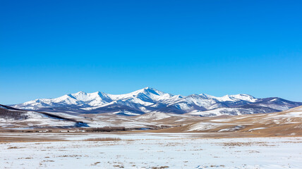 Poster - Snow capped mountains under clear blue sky create serene winter landscape