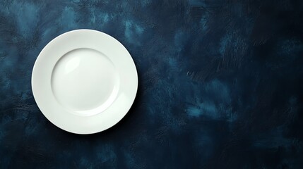 Wall Mural - Empty white plate on a blue textured background.