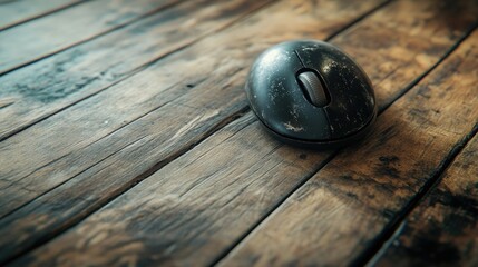 Poster - A close-up of a tired computer mouse with a trackball, lying on an old wooden floor, reflecting years of use and wear in a home office setting.