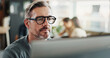 © Clement C/peopleimages.com - Glasses, research and computer with business man in office for planning, networking or company newsletter. Website designer, vision and online with mature person in creative startup for proposal